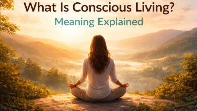 woman meditating on a mountain at sunrise representing conscious living meaning and emotional awareness